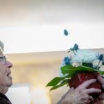 woman receiving flowers at carrier law veterans day dinner