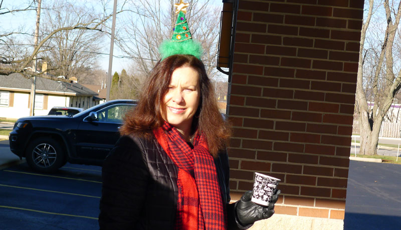 attorney clare clary wears a fun christmas tree hat during the cookie and cocoa drive-by event