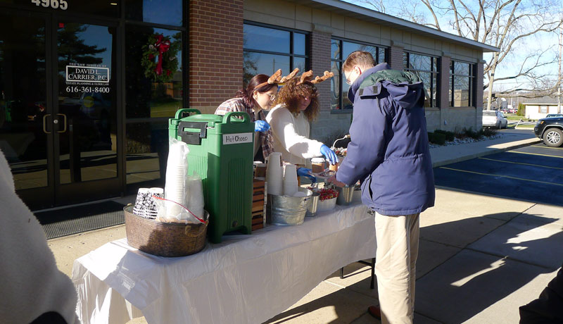 carrier law team members prepare treats for the cookie and cocoa drive-by