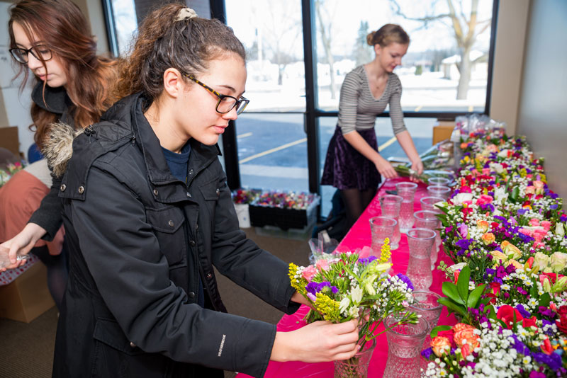 David Carrier staff and Rockford High students deliver Valentine's flowers
