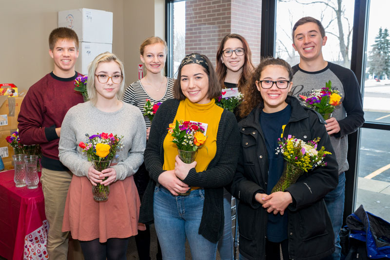 David Carrier staff and Rockford High students deliver Valentine's flowers