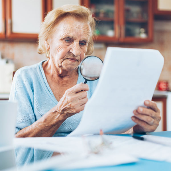 elderly woman reviewing estate planning documents carrier law