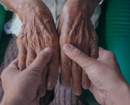caring hands protecting from elder abuse