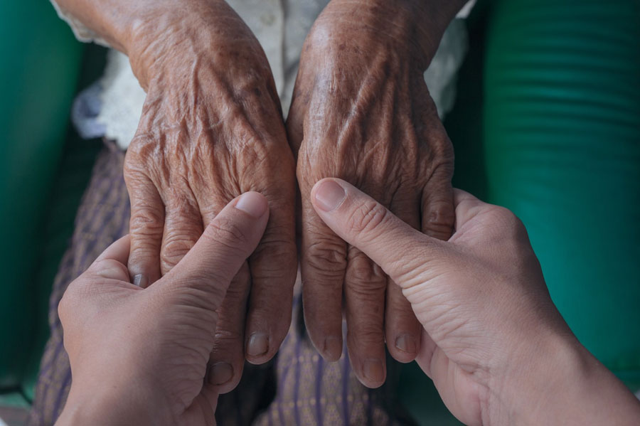 caring hands protecting from elder abuse
