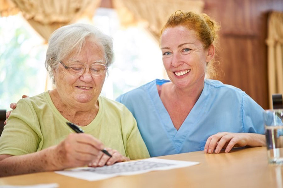 woman with nurse in skilled-nursing home facility